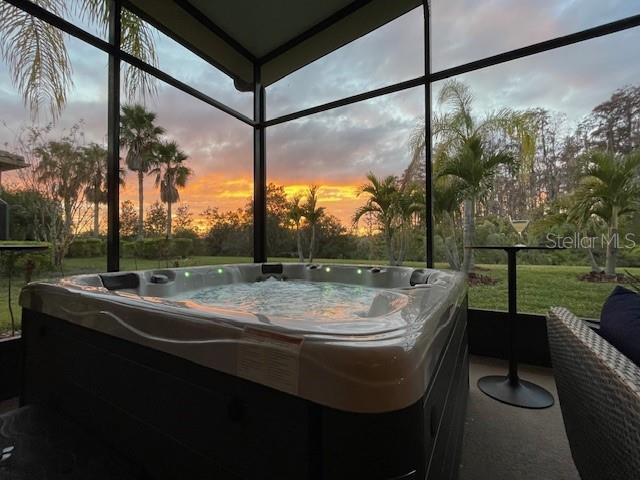 sunroom / solarium featuring a jacuzzi