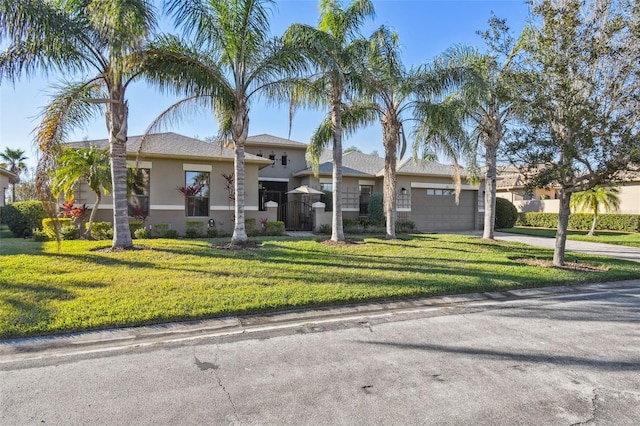 view of front of home with a garage and a front yard