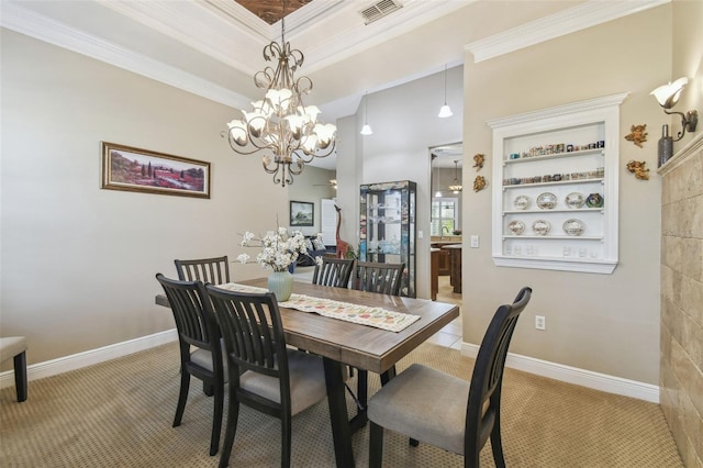 dining area with built in features, a chandelier, ornamental molding, a raised ceiling, and light carpet