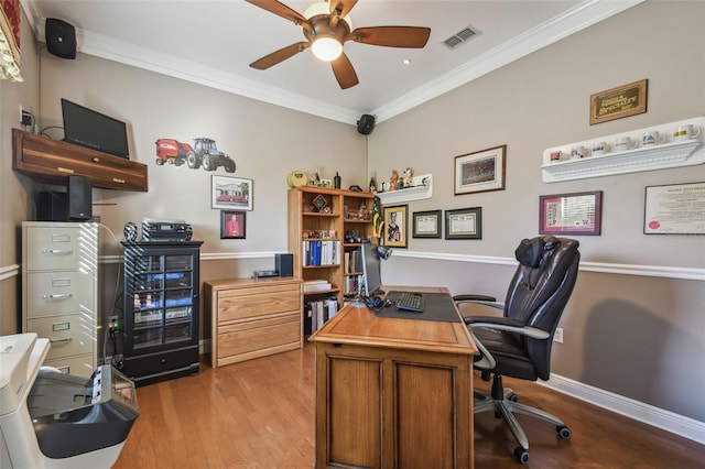 home office with ornamental molding, light hardwood / wood-style floors, and ceiling fan