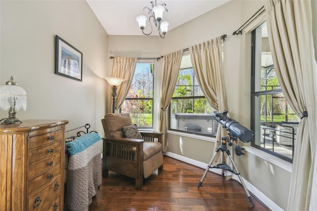 sitting room featuring dark wood-type flooring and a chandelier