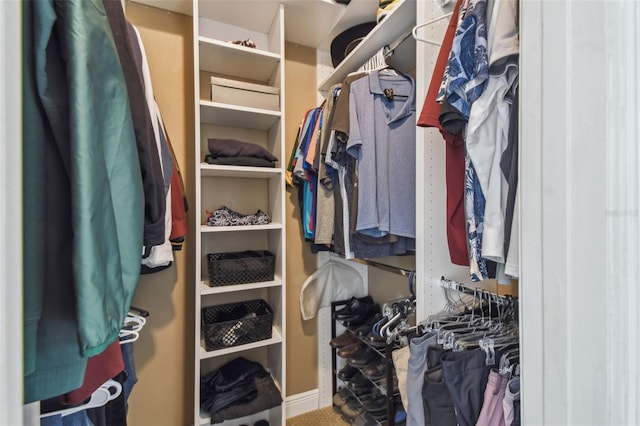 walk in closet with carpet