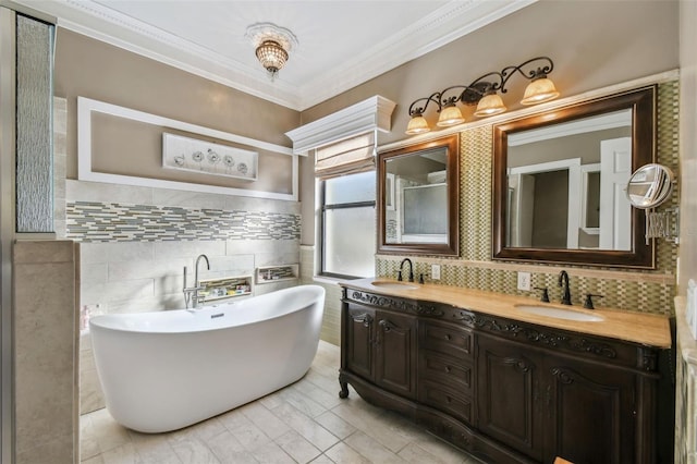 bathroom featuring tile walls, a bathtub, vanity, crown molding, and tile patterned floors