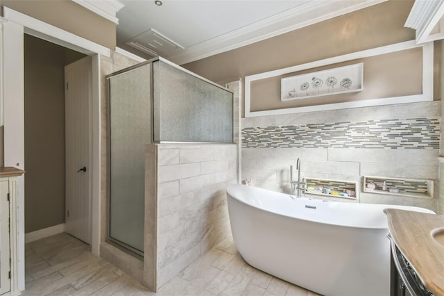 bathroom featuring vanity, ornamental molding, shower with separate bathtub, and tile walls