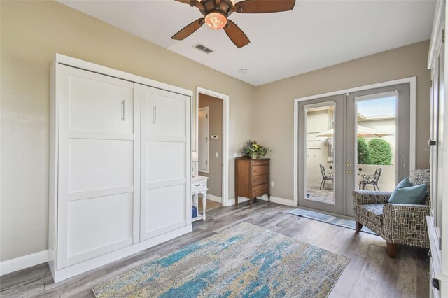 interior space featuring light hardwood / wood-style floors, french doors, and ceiling fan