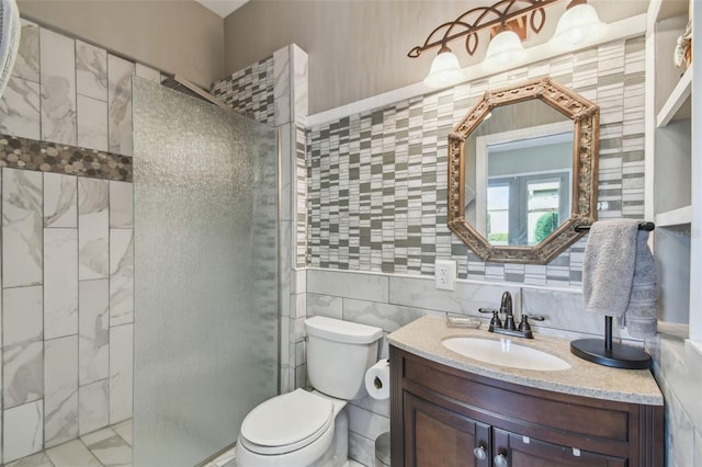 bathroom featuring walk in shower, vanity, toilet, and tile walls