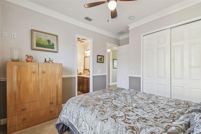 bedroom with ensuite bathroom, ornamental molding, carpet floors, a closet, and ceiling fan