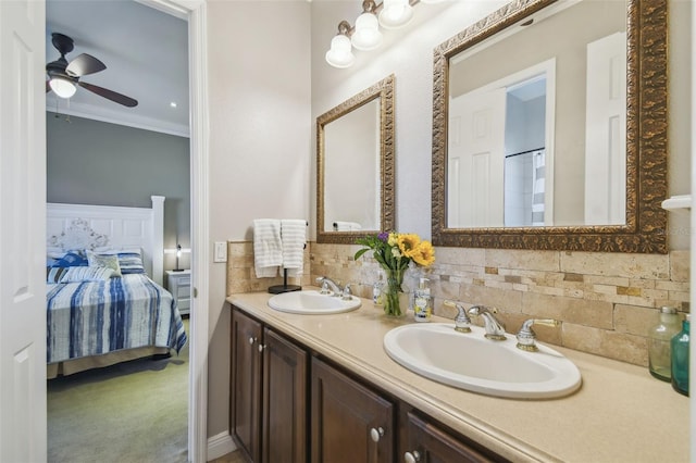 bathroom featuring vanity, crown molding, tasteful backsplash, and ceiling fan