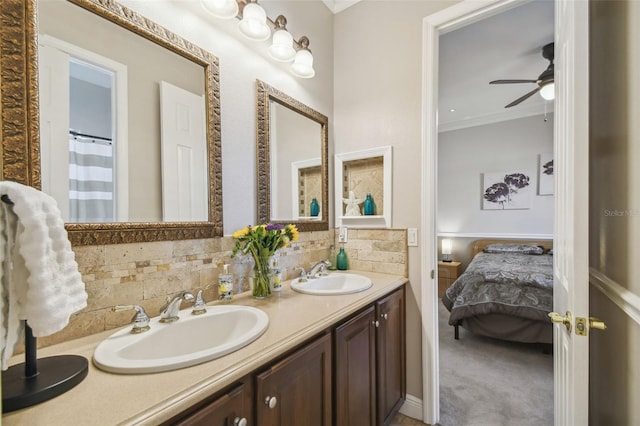 bathroom with tasteful backsplash, ornamental molding, vanity, and ceiling fan