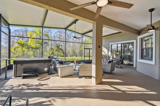 view of patio featuring a hot tub, outdoor lounge area, and ceiling fan