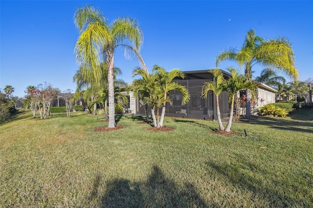 view of front of house with a sunroom and a front yard