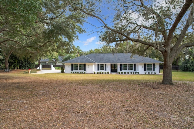 ranch-style home with a front lawn