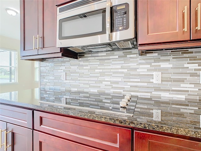 kitchen featuring dark stone countertops and backsplash