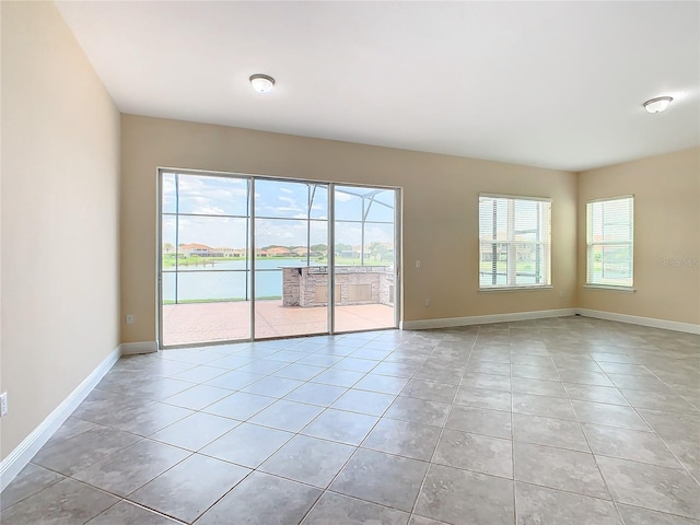 tiled empty room with a water view