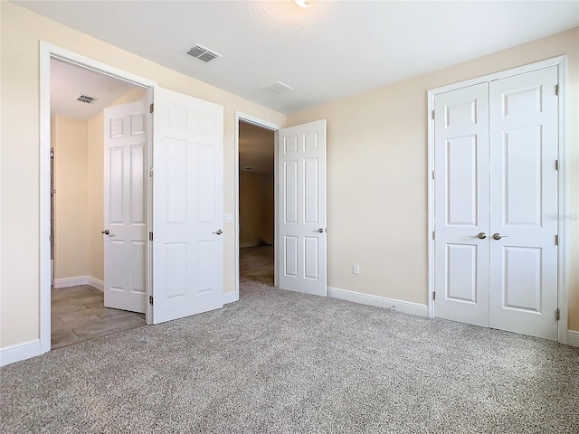 unfurnished bedroom with light colored carpet