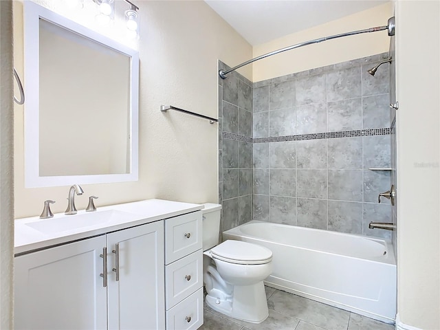 full bathroom featuring toilet, tile patterned floors, tiled shower / bath, and vanity