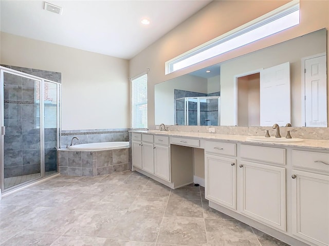 bathroom featuring separate shower and tub, vanity, and tile patterned flooring