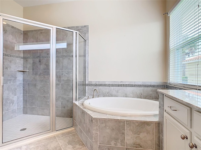 bathroom featuring separate shower and tub, vanity, and tile patterned flooring