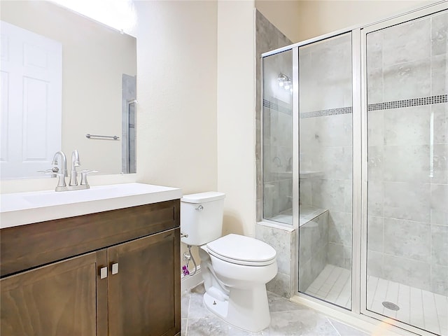 bathroom with tile patterned floors, toilet, vanity, and an enclosed shower