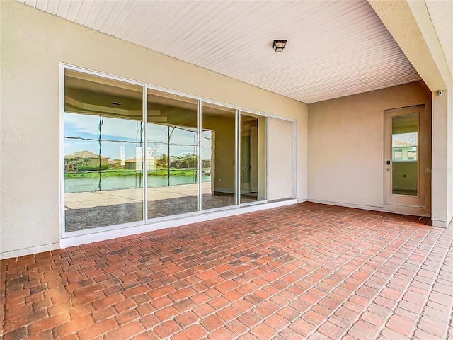 view of patio with a water view