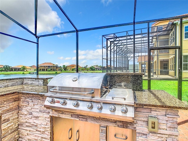 view of patio / terrace featuring area for grilling, a lanai, grilling area, and a water view