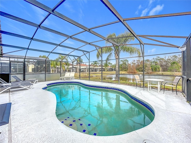 view of swimming pool featuring a patio area, a lanai, and a water view