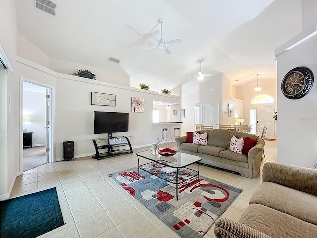 tiled living room with high vaulted ceiling and ceiling fan