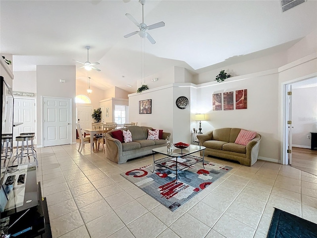 tiled living room with high vaulted ceiling and ceiling fan