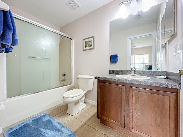 full bathroom featuring tile patterned floors, shower / bath combination with glass door, vanity, and toilet