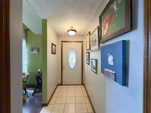 doorway featuring light tile patterned floors and a textured ceiling