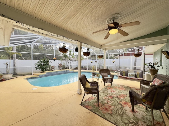 view of swimming pool featuring glass enclosure and a patio