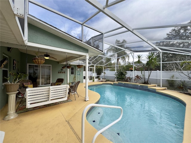 view of pool with a lanai, ceiling fan, a patio area, and an outdoor hangout area