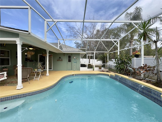 view of pool featuring glass enclosure and a patio