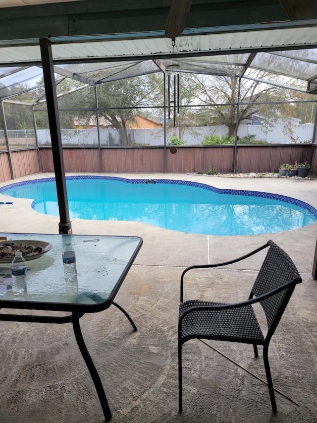 view of swimming pool with a lanai, a fenced backyard, and a fenced in pool