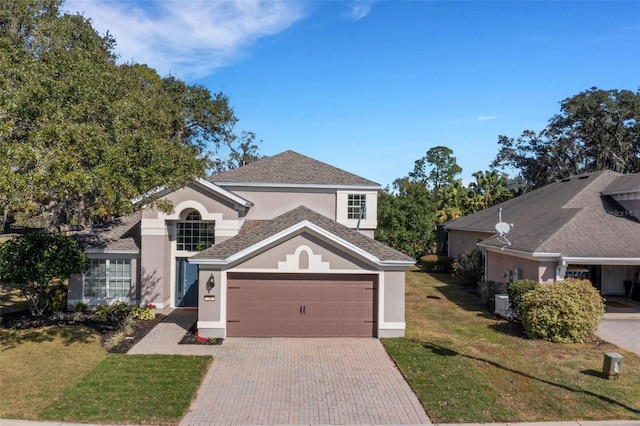 front facade featuring a garage and a front lawn