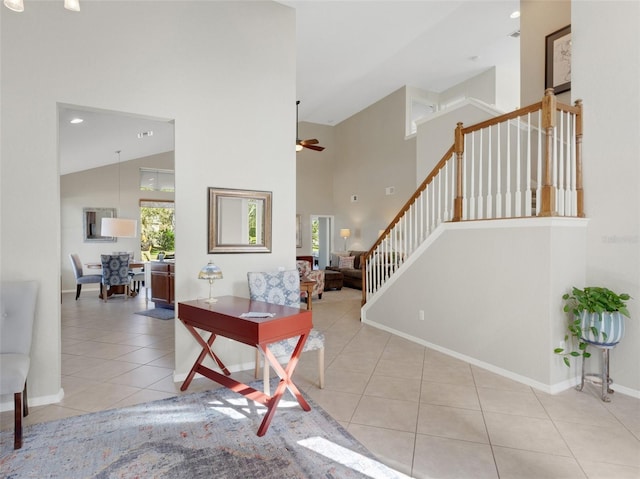 tiled entrance foyer featuring high vaulted ceiling and ceiling fan