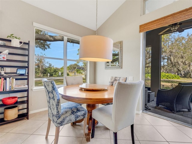 dining area featuring lofted ceiling and light tile patterned floors