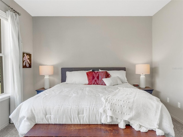 bedroom with dark colored carpet