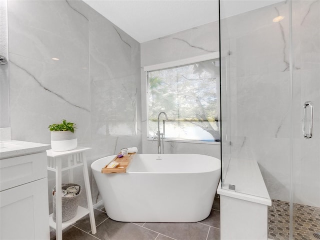 bathroom featuring plus walk in shower and vanity