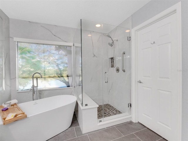 bathroom featuring tile patterned flooring and separate shower and tub