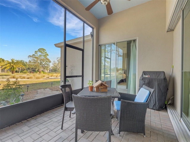 sunroom featuring ceiling fan