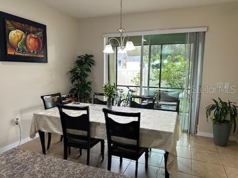 dining area with an inviting chandelier and light tile patterned floors