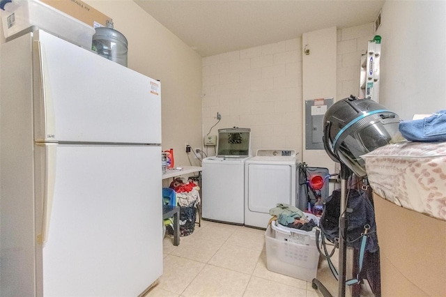 laundry room with laundry area, light tile patterned floors, and separate washer and dryer