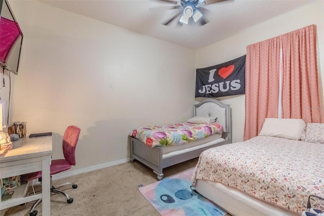 carpeted bedroom with ceiling fan and baseboards