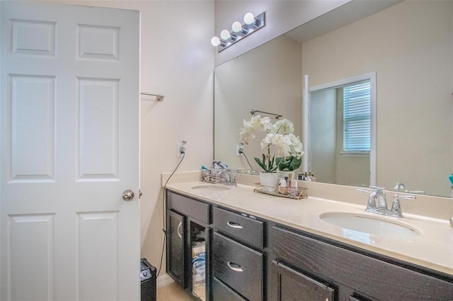 bathroom featuring a sink and double vanity