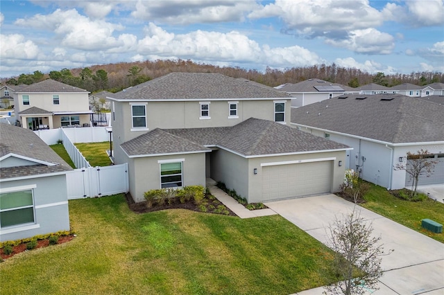 view of front of property featuring a garage and a front yard