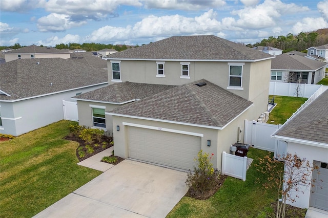 view of front of property featuring a garage and a front lawn