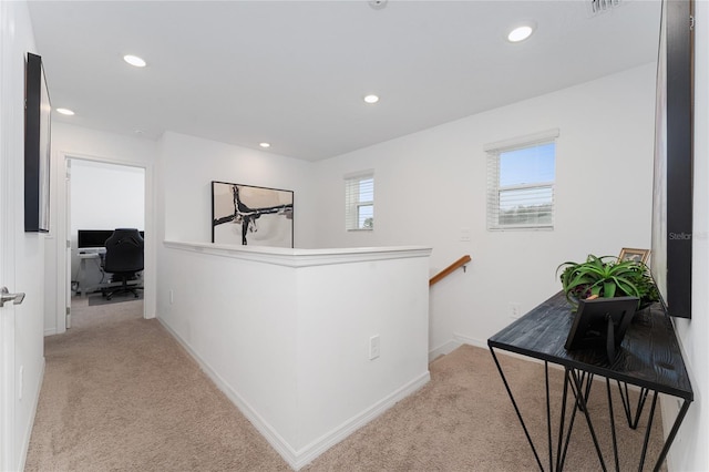 hallway with light colored carpet