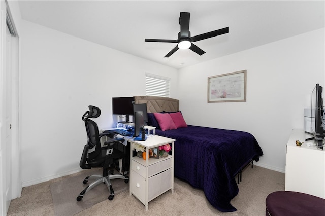 bedroom with ceiling fan, light carpet, and a closet