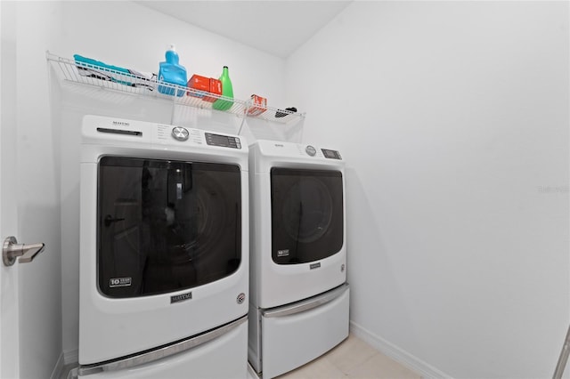 laundry room with light tile patterned floors and independent washer and dryer